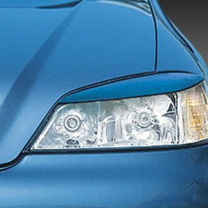 Close-up of a blue car's headlight and front grille against a gray gradient background.