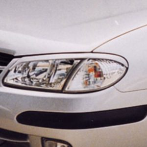 Close-up of the front end of a silver/white car, showing the headlight, grille, and bumper.
