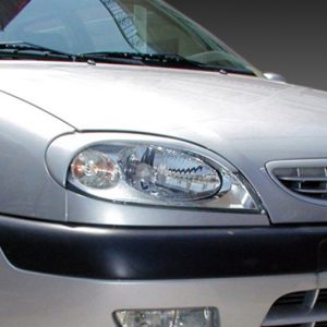 Front view of a silver car showing the headlight, grille with a double-chevron badge, and black bumper trim.