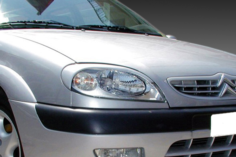 FR000014_1jpg - OPSHOLDERS Front view of a silver car showing the headlight, grille with a double-chevron badge, and black bumper trim.