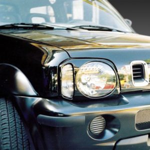Front-left view of a black Suzuki SUV, showing the headlight, seven-slot grille, and front bumper.