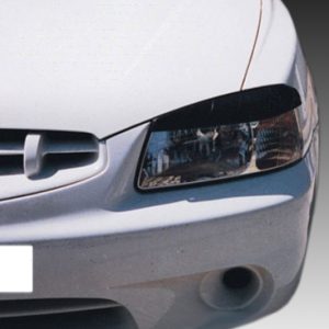 Front view of a silver car showing the headlight, grille, and bumper against a gradient background.