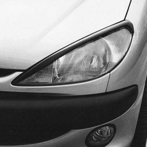 Close-up of the front left corner of a silver car, showing the headlight, bumper, and fog light.