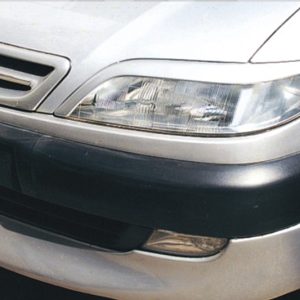Close-up of a silver car's front end, showing the headlight, grille, and bumper.