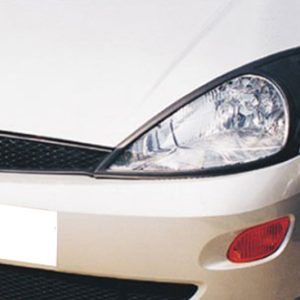 Close-up of the front end of a white Ford car, showing the headlight, grille, and bumper