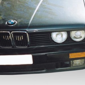 Front view of a dark BMW showing the kidney grille and dual round headlights of the car's front end
