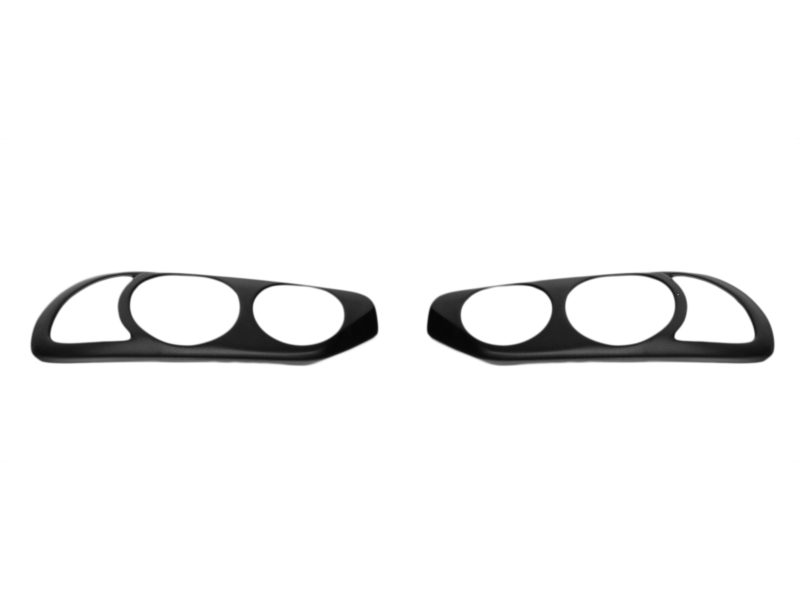 Pair of black car headlight bezels laid flat on a white background, showing left and right sides with circular cutouts in each bezel