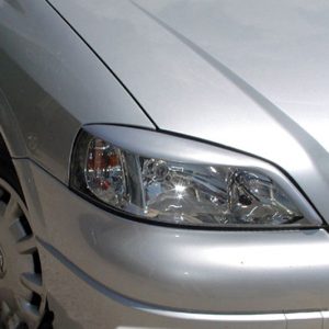 Silver car front-left view showing headlight, fender, and wheel rim in daylight