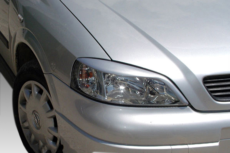 FR000057_1jpg - OPSHOLDERS Silver car front-left view showing headlight, fender, and wheel rim in daylight