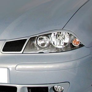 Front end of a silver car, close-up on the headlight, grille, and bumper.