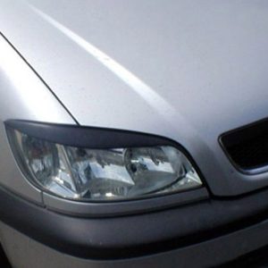 Close-up of the front end of a silver Opel vehicle, showing the left headlight and the Opel badge on the grille