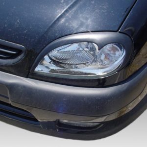 Front end of a dark car showing the headlight, grille, and bumper (license plate obscured).