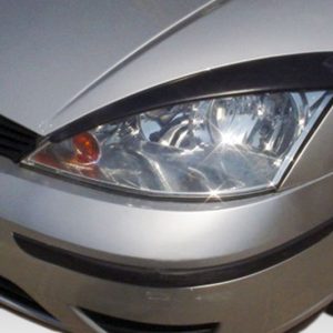 Close-up of a silver car's front-left headlight and bumper, with a black grille and curved hood edge visible.