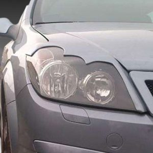 Front-left view of a silver sedan showing the headlight, bumper, and grille