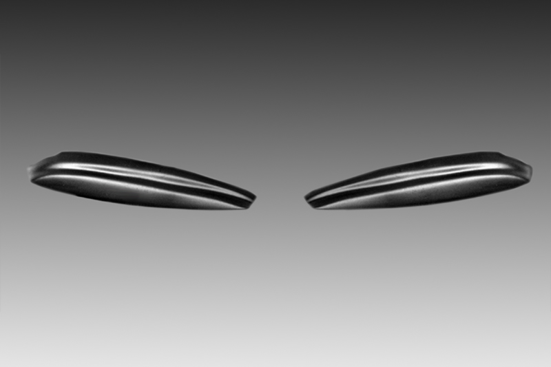 FR000090_1jpg - OPSHOLDERS Two glossy, seed-shaped objects floating apart against a gray gradient background.