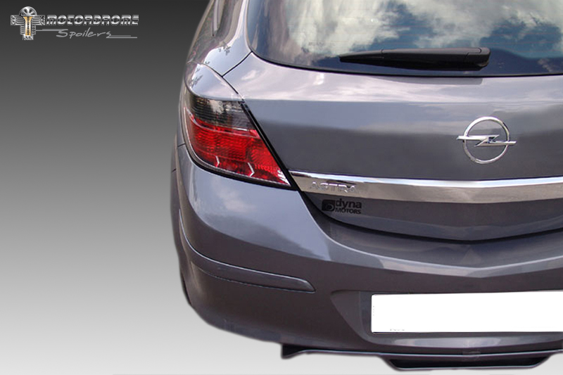 FR000093_1jpg - OPSHOLDERS Rear view of a gray Opel Astra hatchback showing taillight, badge, and chrome trim; includes a Dyna Motors sticker on the trunk and watermark in corner.