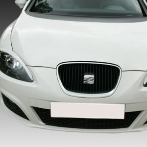 Front view of a white car facing the camera, showing the grille, headlights, and blurred license plate area