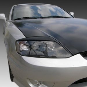 Front-left view of a silver sedan with a dark, glossy hood reflecting the sky.