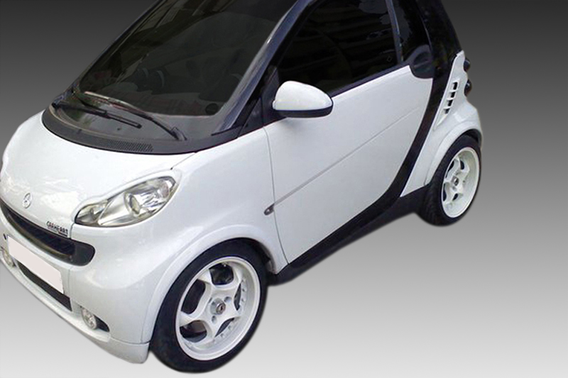 FR000126_1jpg - OPSHOLDERS White compact hatchback car photographed from the front-left, showing rounded headlights and black trim details.