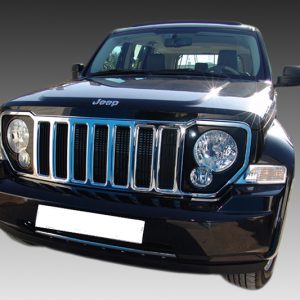 Front view of a black Jeep SUV with a seven-slot chrome grille and round headlights.