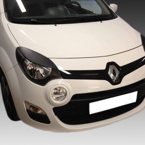Front-angle view of a white Renault car, showing the grille with the Renault logo and circular fog lights on the bumper.