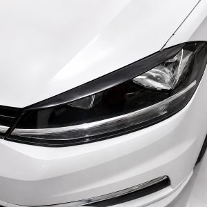 FR000144_3jpg - OPSHOLDERS Close-up of a white car's headlight and front bumper area.