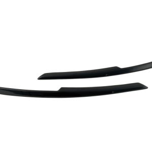 Two glossy black curved car spoiler fins laid horizontally on a white background, with one slightly above the other.