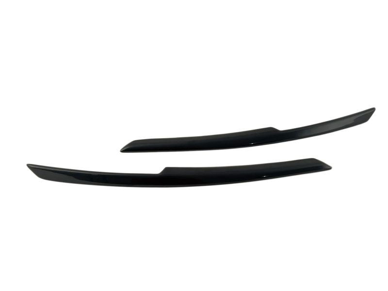 Two glossy black curved car spoiler fins laid horizontally on a white background, with one slightly above the other.