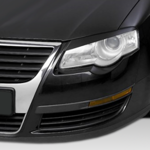 Close-up of the front left corner of a black Volkswagen, displaying the headlight, chrome grille, and wheel.