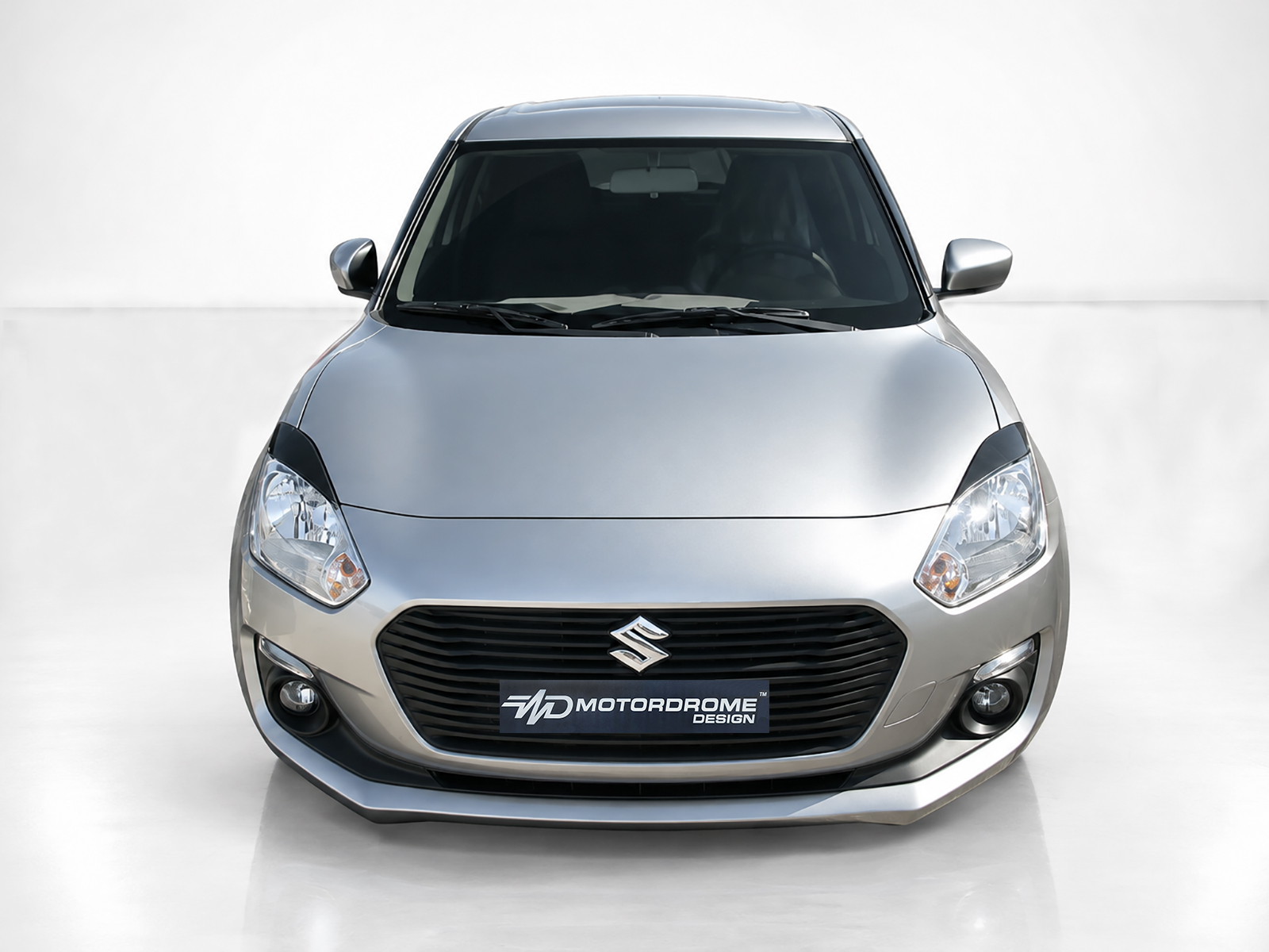 FR000155_2jpg - OPSHOLDERS Front view of a silver Suzuki car, showing grille, headlights, and emblem in a neutral studio setting.