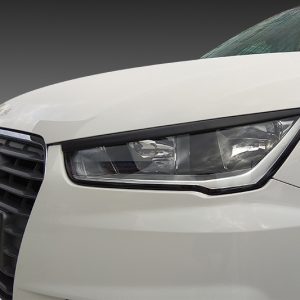 Front-left view of a white Audi, showing the headlight and front grille.