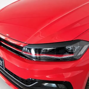 FR000157_3jpg - OPSHOLDERS Front-left detail of a red Volkswagen car, featuring the emblem, grille, and headlight close-up.