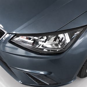 Front-left corner of a metallic blue car, showing the headlight and grille with a glossy hood reflection on a white showroom floor