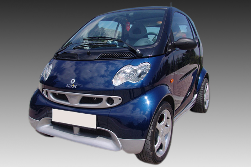K104-001_1jpg - OPSHOLDERS Blue Smart car photographed from a front-left angle, showing compact design and shiny finish.