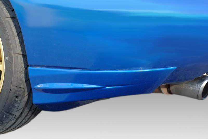 K105-002_1jpg - OPSHOLDERS Close-up of a blue car's lower side panel near the rear wheel with a visible exhaust tip beneath.