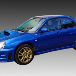 Blue four-door sports car with a hood scoop, gold alloy wheels, and a large rear wing viewed from the front-left side