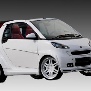 White compact hatchback with red interior and oversized white alloy wheels set against a gray gradient background.
