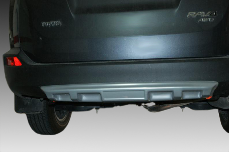 K141-002_1jpg - OPSHOLDERS Rear view of a dark Toyota RAV4 showing the bumper and undercarriage from beneath, with 'TOYOTA' on the left and 'RAV4 AWD' badge on the right visible.