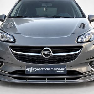 Front view of a silver Opel car showing headlights, grille with emblem, and bumper detail. Plate reads MD MotorDrome Design (brand display).