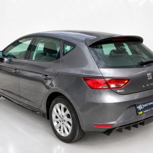 Gray SEAT Leon hatchback shown from rear three-quarter view in a bright showroom