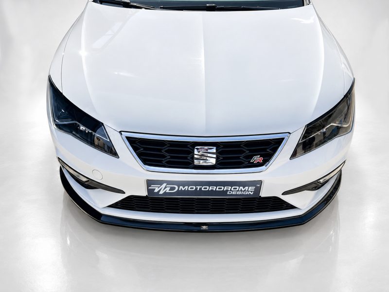 Top-down view of a white car front, showing the grille, headlights, and hood edges.