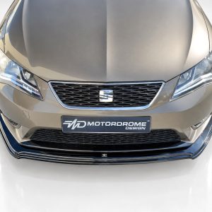 K150-007_3jpg - OPSHOLDERS Front view of a metallic gray car showing a honeycomb grille, LED headlights, and a MOTORDROME DESIGN plate in the center.