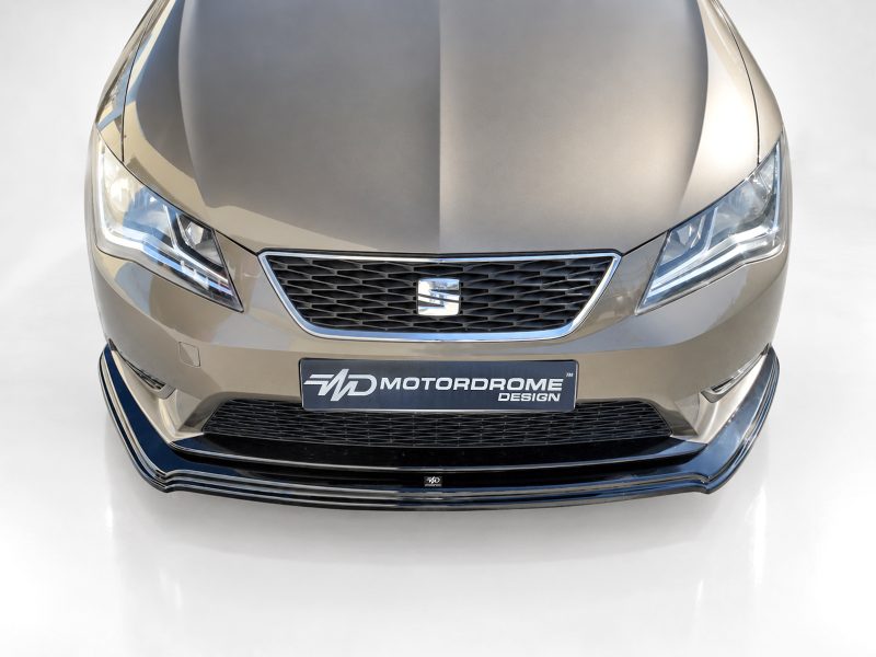 K150-007_3jpg - OPSHOLDERS Front view of a metallic gray car showing a honeycomb grille, LED headlights, and a MOTORDROME DESIGN plate in the center.