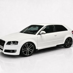 Three-quarter front view of a white hatchback car with dark windows and black alloy wheels in a studio setting