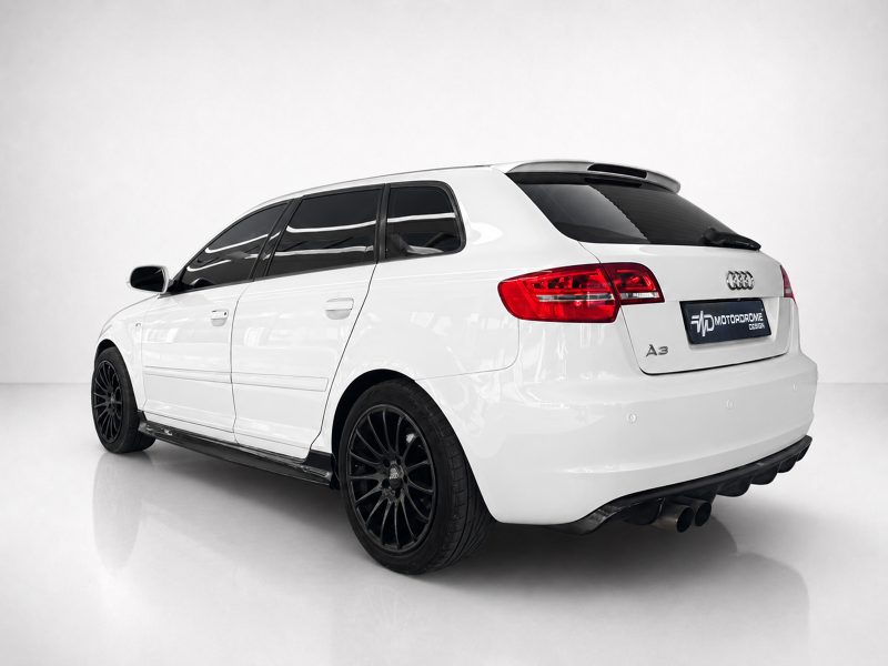 K151-004_5jpg - OPSHOLDERS Rear three-quarter view of a white Audi A3 Avant with black multi-spoke wheels in a studio setup, plate reads 'MOTORROME DESIGN'