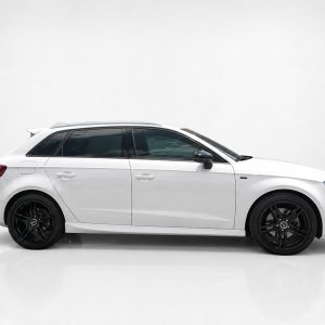 Side view of a white SUV with black alloy wheels on a white studio background.
