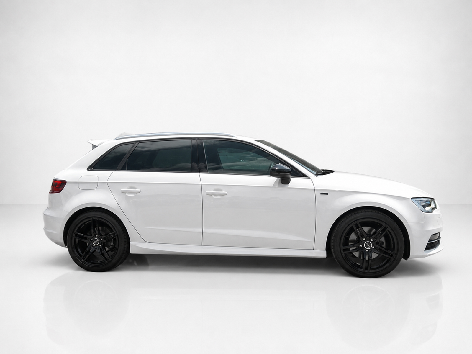 K152-003_1jpg - OPSHOLDERS Side view of a white SUV with black alloy wheels on a white studio background.