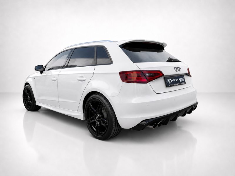 K152-003_3jpg - OPSHOLDERS Rear three-quarter view of a white Audi hatchback with black aftermarket wheels in a studio setting