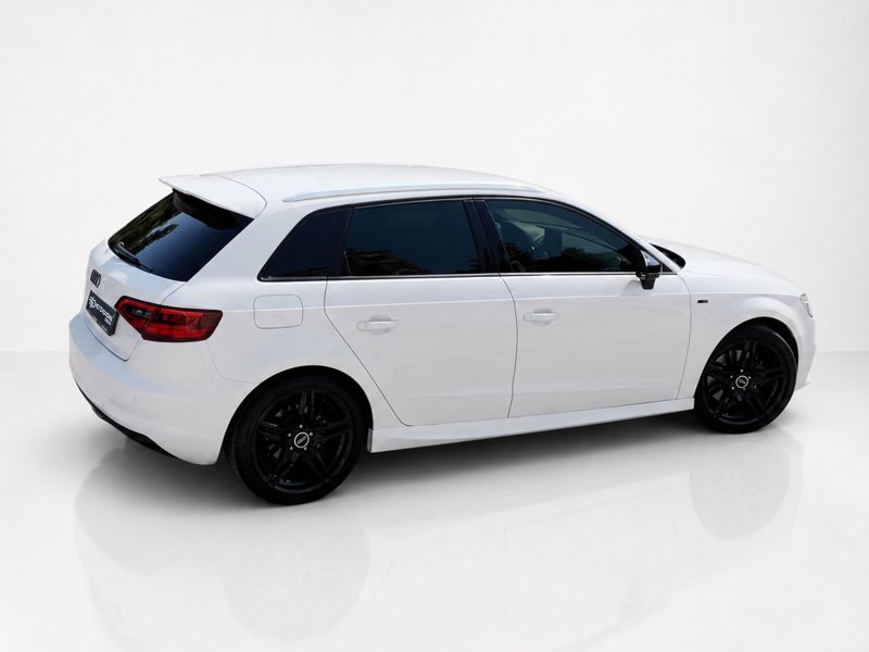 K152-003_4jpg - OPSHOLDERS White station wagon with black alloy wheels viewed from the rear-right in a bright studio setting, glossy floor reflections visible.
