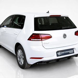 White Volkswagen Golf hatchback shown from the rear-left in a studio, highlighting the taillights, VW emblem, and 'GOLF' badge.